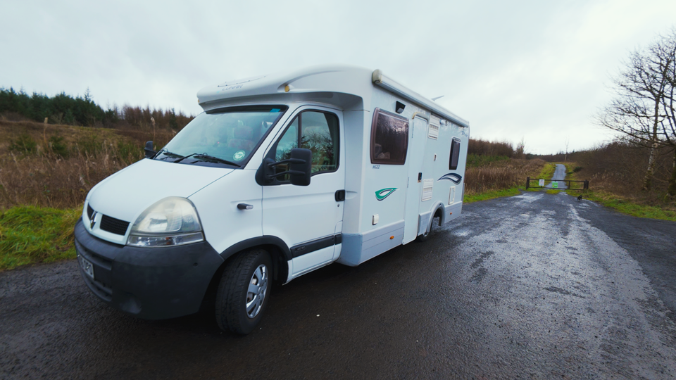 A recently cleaned motorhome in a forest car park