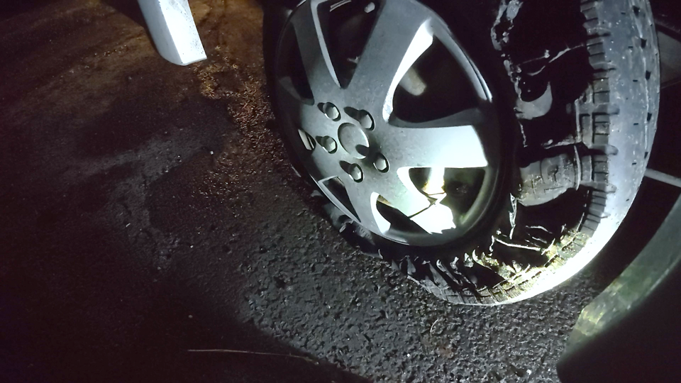 A blow out tyre on a motorhome at night.